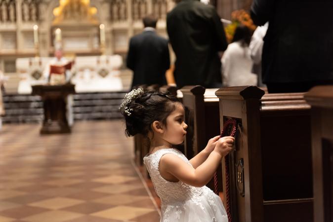 Little girl plays in Trinity Church on All Saints Sunday 2021