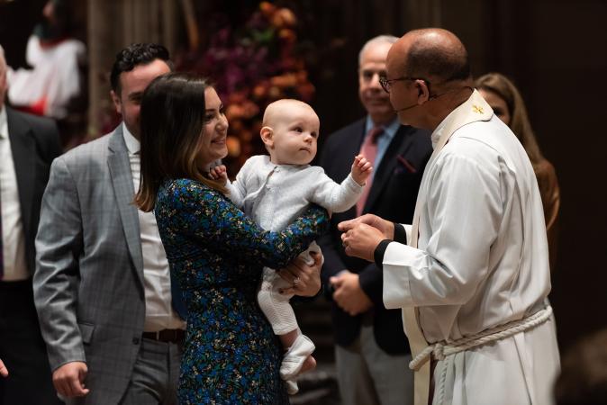 A child is blessed in Trinity Church on All Saints Sunday 2021
