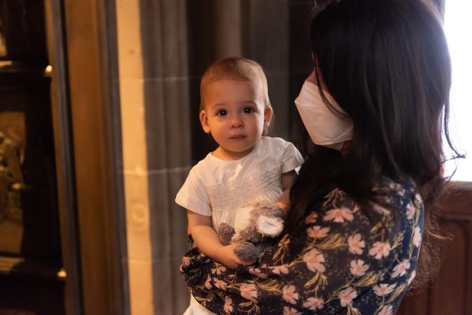A child with mom in Trinity Church on All Saints Sunday 2021