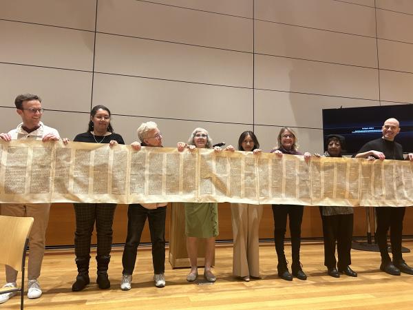 Into the Word participants hold up a Torah Scroll during Rabbi Darren Levine's presentation, February 1, 2024