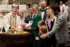 A child is baptized in Trinity Church on All Saints Sunday 2021