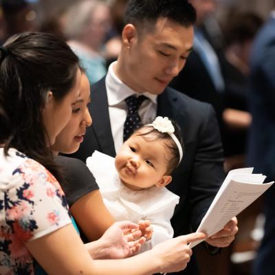 Family participates in service before baptism ceremony.