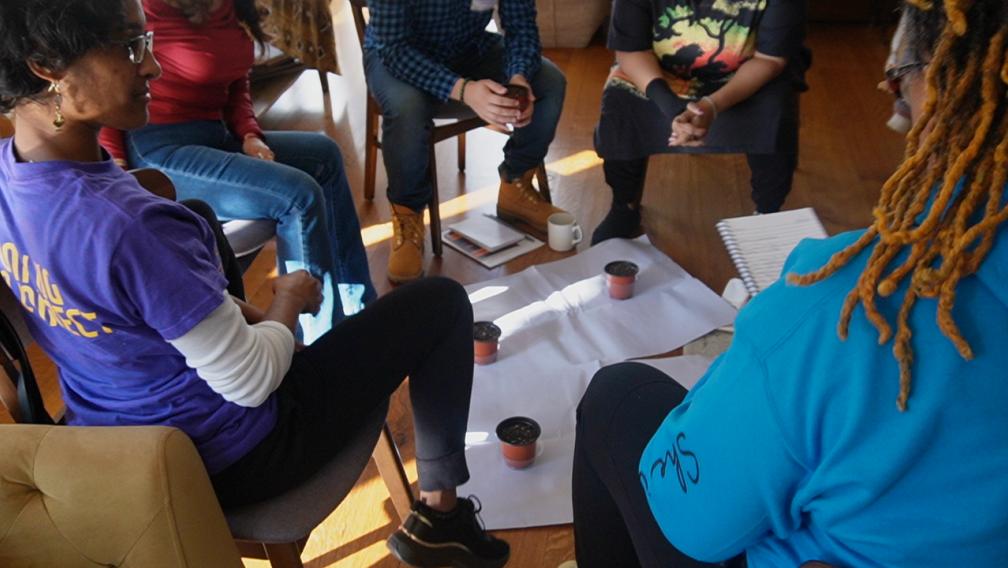 Who Keeps the Keeper program participants sit in a circle in group discussion at the Trinity Retreat Center.