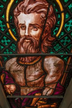 St. Luke represented in the stained glass in Trinity Church.