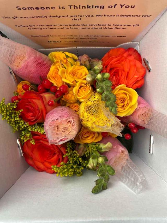 A box of colorful yellow, pink and orange flowers