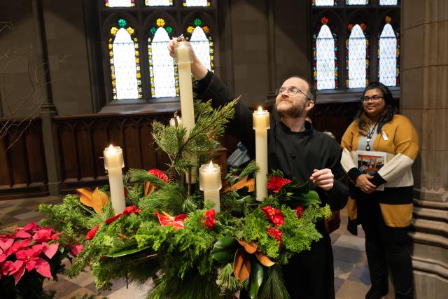 Dane Miller lights Advent candles in Trinity Church
