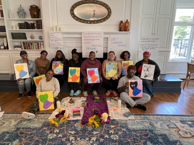 WKTK participants smile with art they created during their "Love and Liberation Kitchen" session at the Trinity Retreat Center.