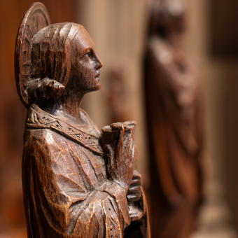 A wooden carving of a figure with eyes looking up, Trinity Church