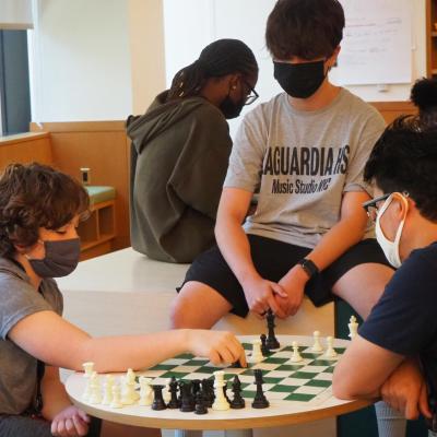 Youth play chess in youth lounge